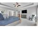 Spacious main bedroom with trey ceilings, a sitting area, and a large TV at 10140 Grandview Sq, Duluth, GA 30097