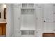 Mudroom features white cabinets with storage and bench, and access to other rooms, offering organization at 10140 Grandview Sq, Duluth, GA 30097