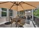 Covered outdoor patio featuring a dining table and umbrella, ideal for outdoor entertaining or relaxation at 10140 Grandview Sq, Duluth, GA 30097