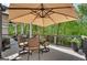 Outdoor patio featuring a dining table with umbrella for shade and chairs, perfect for al fresco meals at 10140 Grandview Sq, Duluth, GA 30097