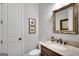 Elegant powder room featuring a marble countertop, decorative mirror, and stylish fixtures at 10140 Grandview Sq, Duluth, GA 30097