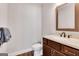 Stylish powder room with dark wood vanity, marble countertop, and modern fixtures for a touch of elegance at 10140 Grandview Sq, Duluth, GA 30097