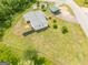 Aerial shot of a charming home with a fenced yard, detached garages, and lush greenery at 40 N Villa Rd, Villa Rica, GA 30180