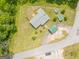 An aerial view of a well-maintained home with a fenced yard, detached garages, and beautiful green spaces at 40 N Villa Rd, Villa Rica, GA 30180