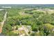 An aerial view of a rural property with a charming house, surrounded by lush greenery at 40 N Villa Rd, Villa Rica, GA 30180
