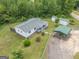 This aerial view shows the home with a metal awning and two sheds with green roofs at 40 N Villa Rd, Villa Rica, GA 30180