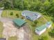 This aerial view shows the home, which features a metal awning and two sheds with green roofs at 40 N Villa Rd, Villa Rica, GA 30180