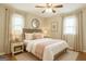 Serene bedroom featuring a comfortable queen bed, soft decor, and abundant natural light from the window at 40 N Villa Rd, Villa Rica, GA 30180
