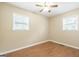 Bright bedroom with hardwood floors, neutral walls, a ceiling fan and plenty of natural light from two windows at 40 N Villa Rd, Villa Rica, GA 30180