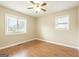 Bright bedroom with hardwood floors, a ceiling fan, neutral walls and plenty of natural light from two windows at 40 N Villa Rd, Villa Rica, GA 30180
