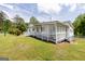 The house features a covered porch, a white vinyl fence, and beautiful landscaping at 40 N Villa Rd, Villa Rica, GA 30180