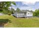 The home features an expansive lawn, a white vinyl fence, and a covered porch with a lattice enclosure at 40 N Villa Rd, Villa Rica, GA 30180