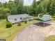 Beautiful exterior view of a bright white home with green carport, fenced yard, landscaping and a welcoming porch at 40 N Villa Rd, Villa Rica, GA 30180