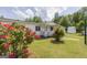 Charming home with a manicured front yard featuring vibrant flowers and a welcoming porch at 40 N Villa Rd, Villa Rica, GA 30180