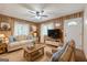 Inviting living room featuring comfortable seating, warm wood paneling, and bright windows with sheer curtains at 40 N Villa Rd, Villa Rica, GA 30180