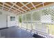 This porch features a white lattice enclosure, a dark stained deck, and a white plastic bench at 40 N Villa Rd, Villa Rica, GA 30180