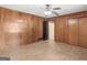 Spacious bedroom with wood paneled walls, ceiling fan, large closets, and a hardwood floor at 3 Ridge Dr, Hampton, GA 30228