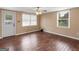 Bedroom features hardwood floors, and dual windows with scenic view at 3 Ridge Dr, Hampton, GA 30228