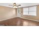 Bright bedroom with hardwood floors, neutral walls, ceiling fan, and a window offering natural light at 3 Ridge Dr, Hampton, GA 30228