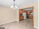 Dining area with hardwood floors, classic lighting, and a view of kitchen and cabinetry at 3 Ridge Dr, Hampton, GA 30228