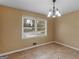 Dining room features hard wood floors and a chandelier with a big window letting in lots of light at 3 Ridge Dr, Hampton, GA 30228
