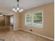 Dining area featuring hardwood floors, views to backyard, and opening to the living and kitchen at 3 Ridge Dr, Hampton, GA 30228