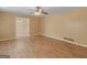 Spacious living room with hardwood floors, ceiling fan, neutral walls, and views to dining area at 3 Ridge Dr, Hampton, GA 30228