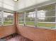 Charming sunroom with brick walls and large windows offering a view of the greenery at 3 Ridge Dr, Hampton, GA 30228