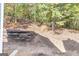Backyard featuring a tiered retaining wall and natural surroundings at 3130 Lower Creek Dr, Douglasville, GA 30135