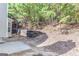 Backyard featuring a tiered retaining wall and natural surroundings at 3130 Lower Creek Dr, Douglasville, GA 30135