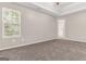 Bedroom with neutral carpet, tray ceiling, and large window at 3130 Lower Creek Dr, Douglasville, GA 30135