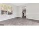 Bright dining area featuring large windows and gray tile flooring, seamlessly transitioning to the kitchen at 3130 Lower Creek Dr, Douglasville, GA 30135