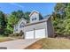Charming home with an attached two-car garage, surrounded by mature trees and a well-maintained lawn at 3130 Lower Creek Dr, Douglasville, GA 30135