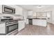 Bright kitchen featuring stainless appliances, stone counters and white cabinetry at 3130 Lower Creek Dr, Douglasville, GA 30135