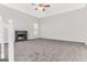 Large carpeted living room featuring a fireplace and ample natural light at 3130 Lower Creek Dr, Douglasville, GA 30135