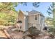 Tan two-story home featuring a fenced backyard surrounded by mature trees providing ample privacy from neighbors at 3130 Lower Creek Dr, Douglasville, GA 30135