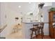 Bright kitchen with white cabinetry, breakfast bar, and ample natural light at 3746 Vineyards Lake Nw Cir # U6, Kennesaw, GA 30144