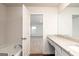Bathroom with a tub and granite vanity countertop, blending style with practicality at 244 Oliver Dr, Locust Grove, GA 30248