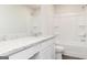 Bathroom features white cabinets and countertop, shower-tub combo, and a toilet at 244 Oliver Dr, Locust Grove, GA 30248