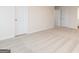 Spacious bedroom with neutral carpeting, two doors, and minimal design at 244 Oliver Dr, Locust Grove, GA 30248