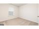 Cozy bedroom includes window, neutral carpeting, and a simple, functional design at 244 Oliver Dr, Locust Grove, GA 30248