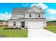 Charming two-story home featuring a two-car garage, brick accents, and a well-manicured lawn at 244 Oliver Dr, Locust Grove, GA 30248