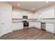 Bright kitchen features white cabinets, stainless steel appliances, and durable wood-look flooring at 244 Oliver Dr, Locust Grove, GA 30248