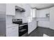 Bright kitchen with stainless steel appliances, subway tile backsplash and white cabinets at 244 Oliver Dr, Locust Grove, GA 30248