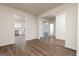 The spacious living room with hardwood floors offers views into the kitchen at 244 Oliver Dr, Locust Grove, GA 30248