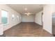 Spacious living room with hardwood flooring, bright windows, and ceiling fan at 244 Oliver Dr, Locust Grove, GA 30248