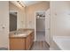 Well-lit bathroom featuring double sinks with granite countertop and views of the bedroom at 145 Tara Way, Covington, GA 30016