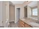 Bathroom featuring a double sink vanity with granite countertops and tub at 145 Tara Way, Covington, GA 30016