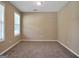Cozy bedroom with neutral walls, carpeted floors, and ample natural light from two windows at 145 Tara Way, Covington, GA 30016