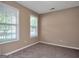 Neutral bedroom featuring natural light from two windows and carpeted floors at 145 Tara Way, Covington, GA 30016
